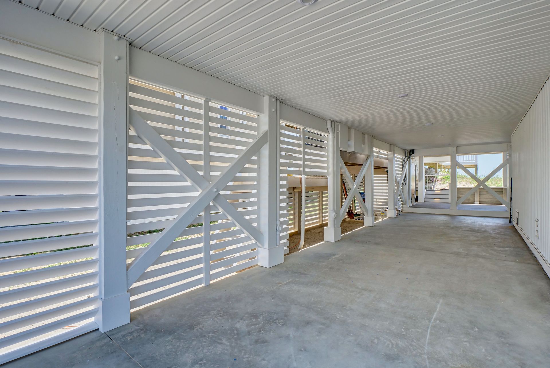 An empty garage with white shutters on the walls