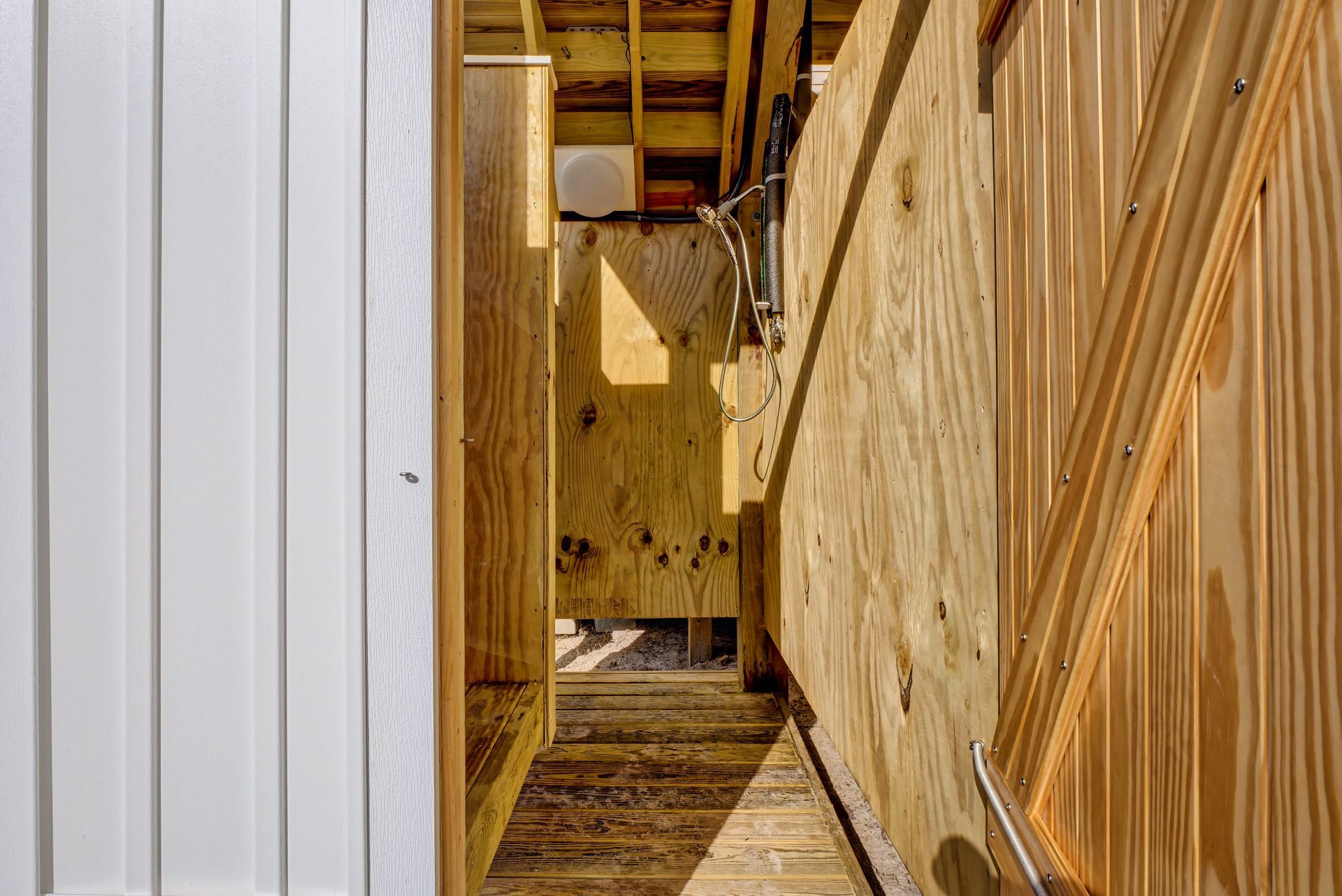 A doorway leading to a wooden building under construction.