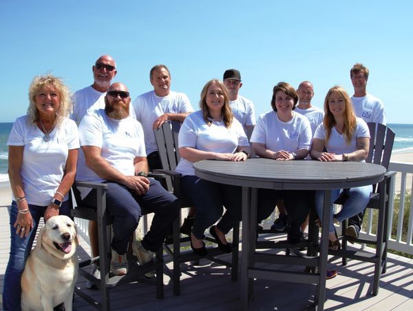 A group of people posing for a picture with a dog