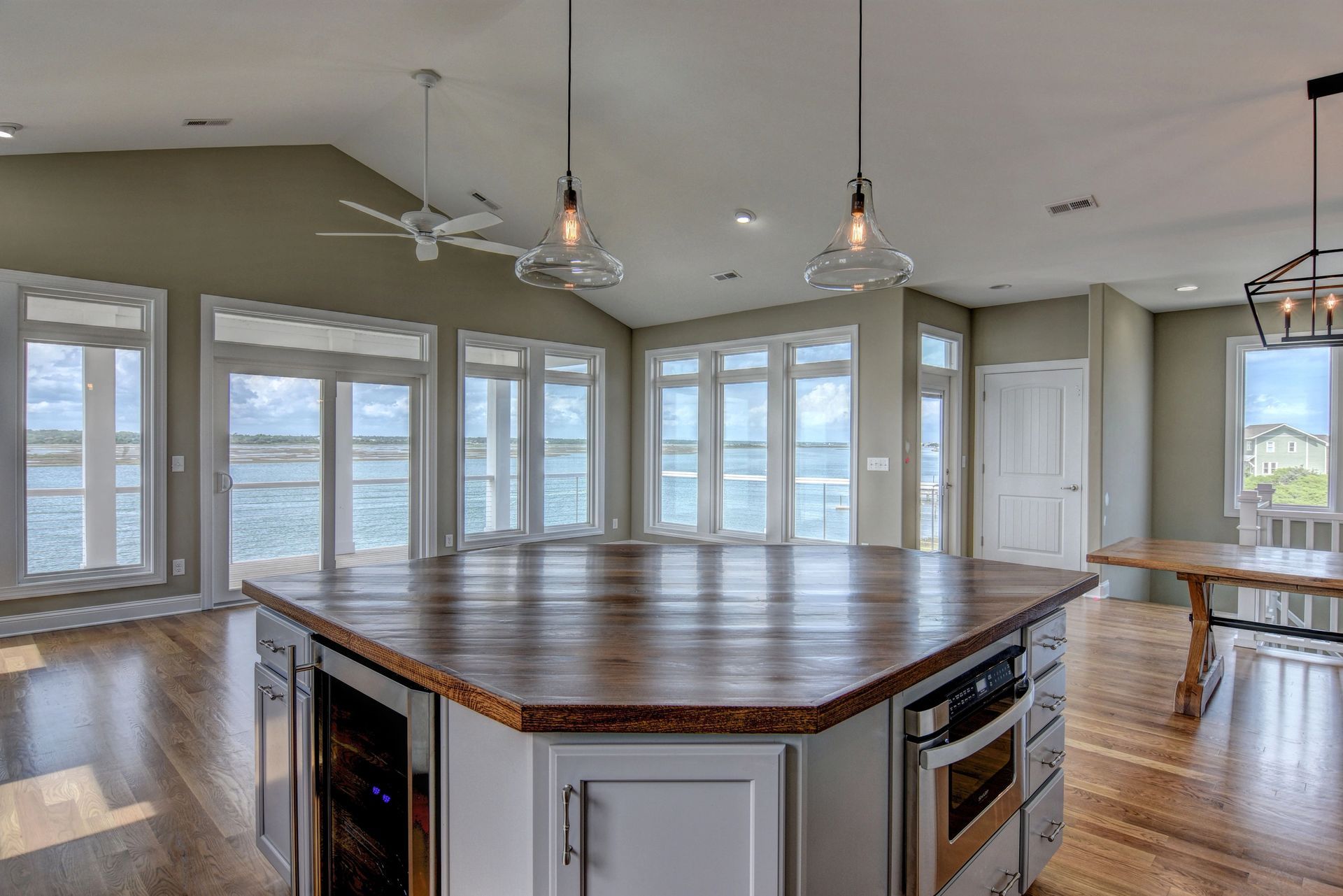 There is a large island in the middle of the room with a view of the ocean.