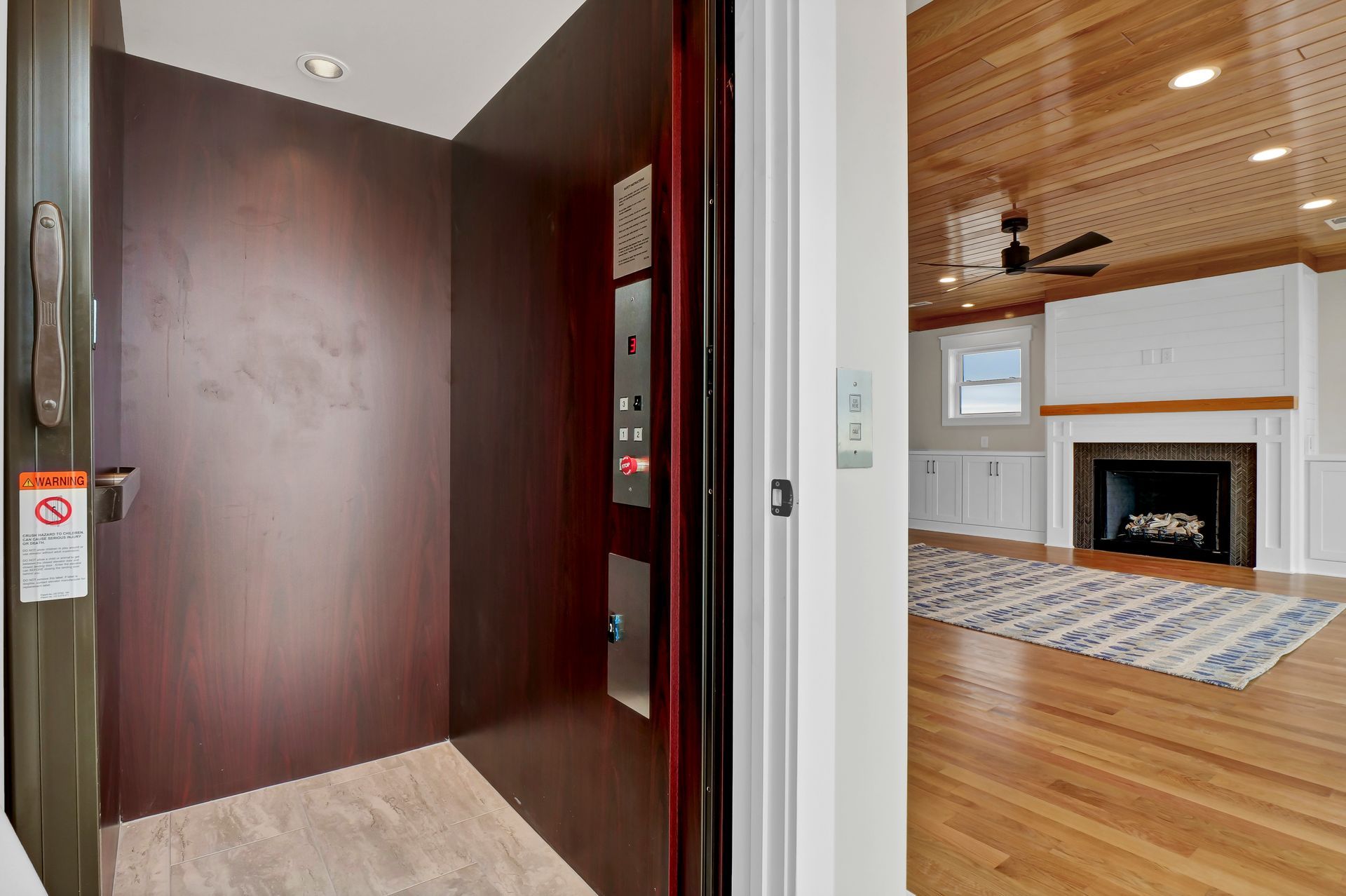 A picture of an elevator and a living room with a fireplace.