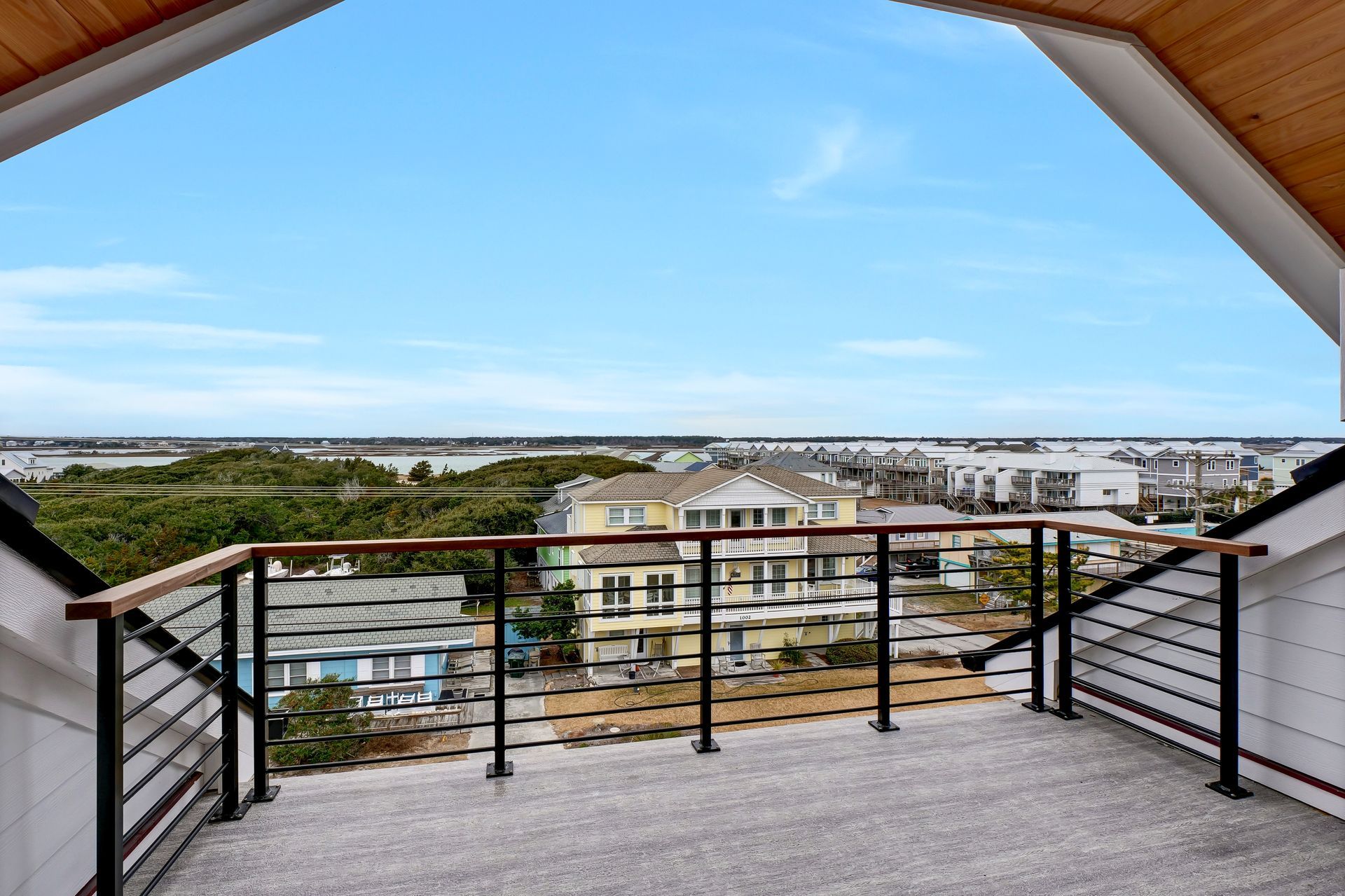 A balcony with a view of a city and trees