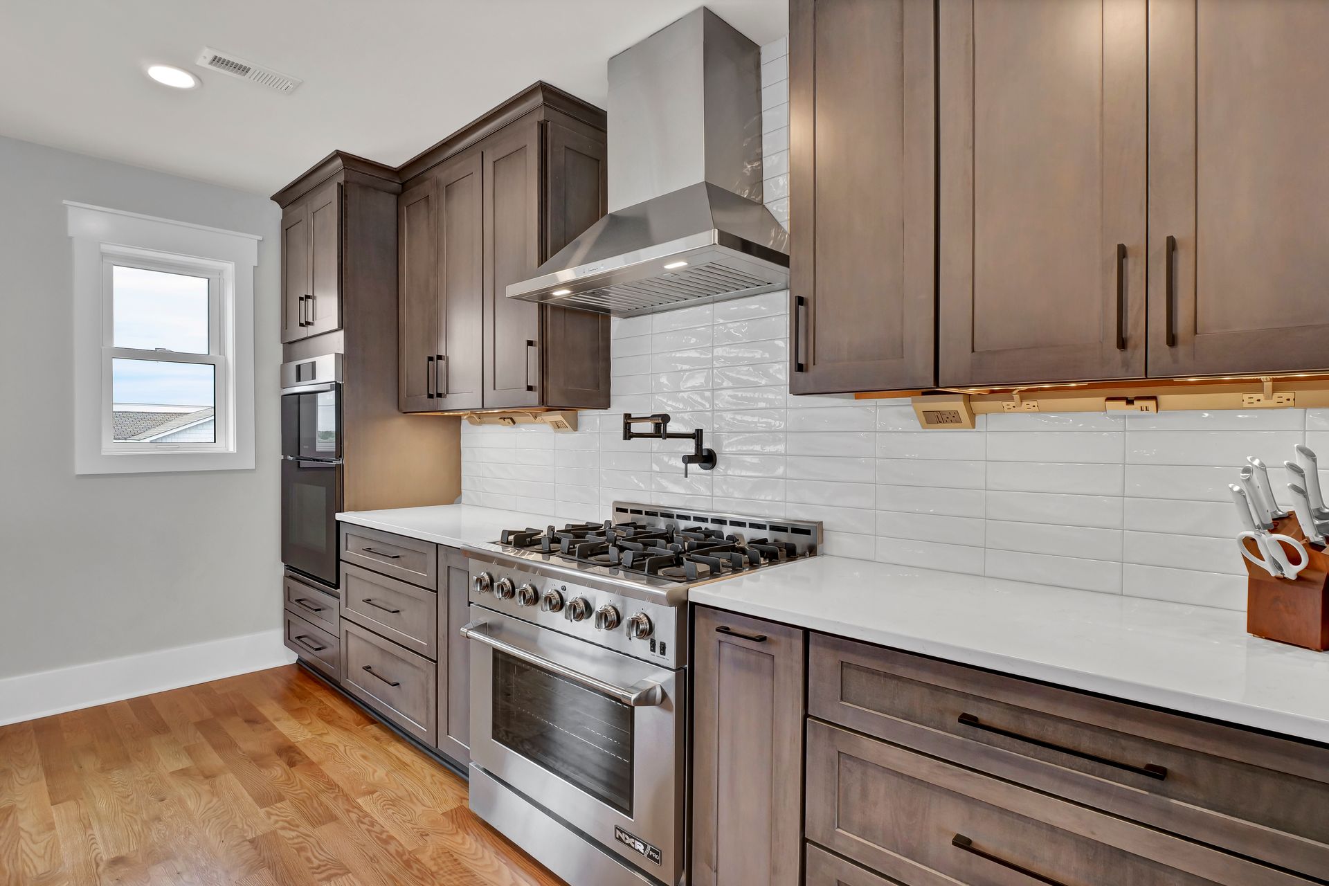 A kitchen with stainless steel appliances and wooden cabinets.