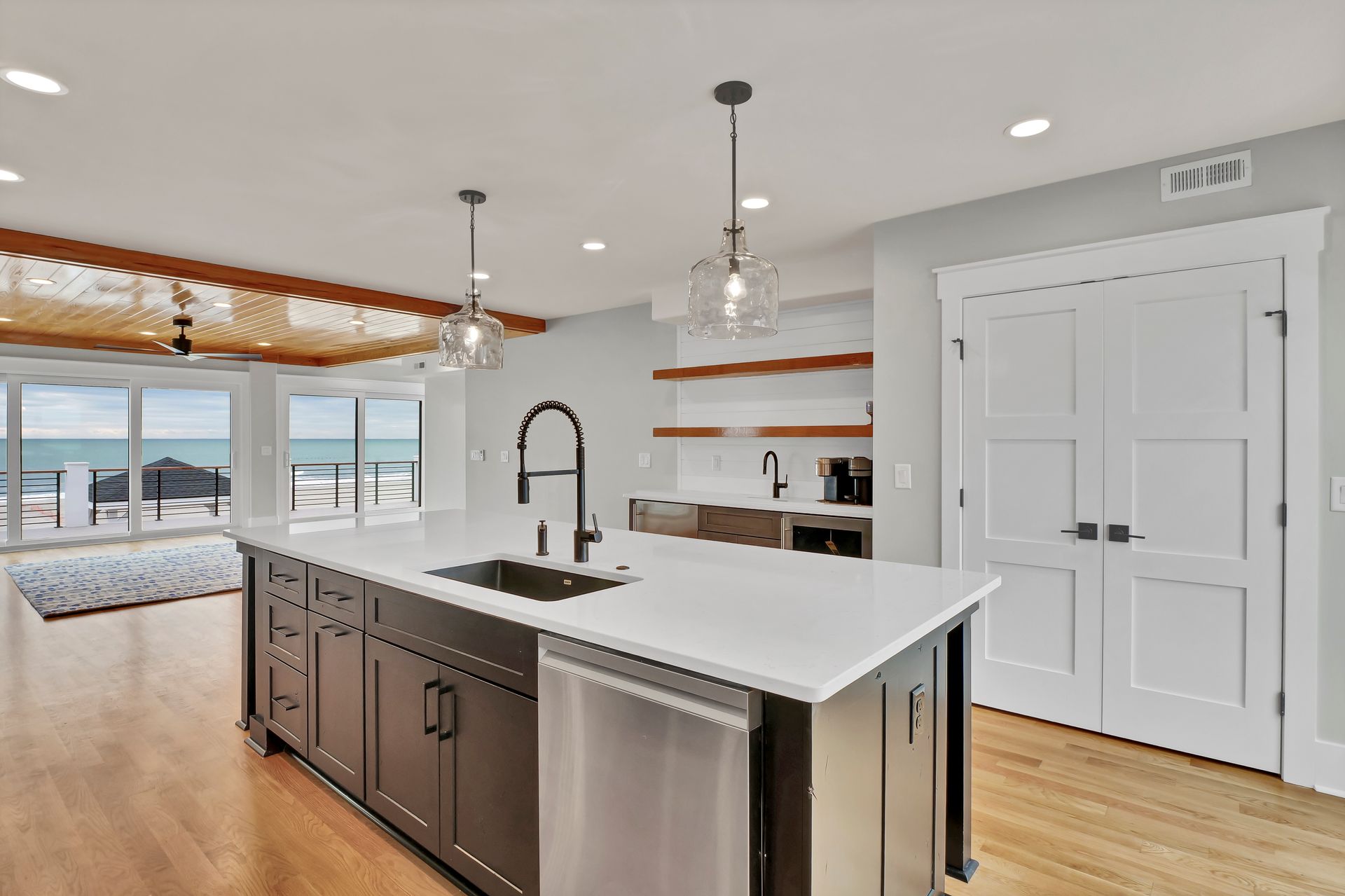 A kitchen with a large island and stainless steel appliances.