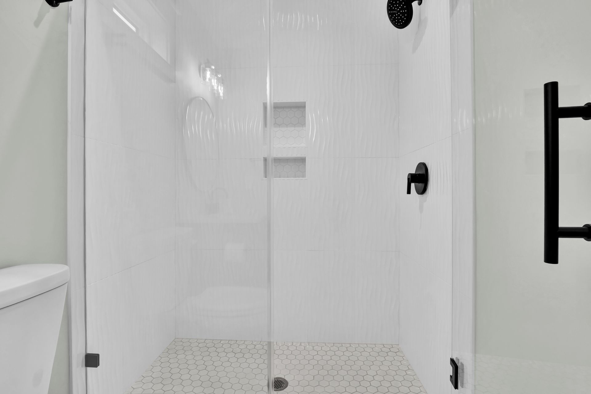 A bathroom with a walk in shower and a toilet.