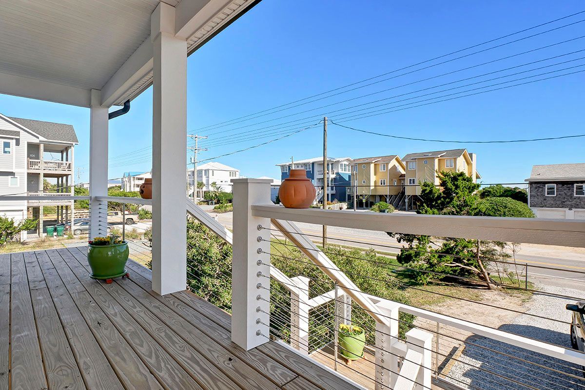A wooden deck with a white railing