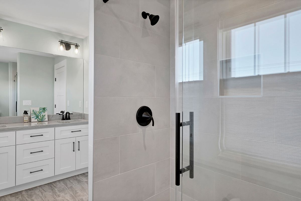 A bathroom with a walk-in shower and a bathtub