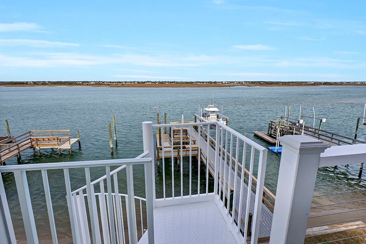 A balcony overlooking a body of water with a dock in the background