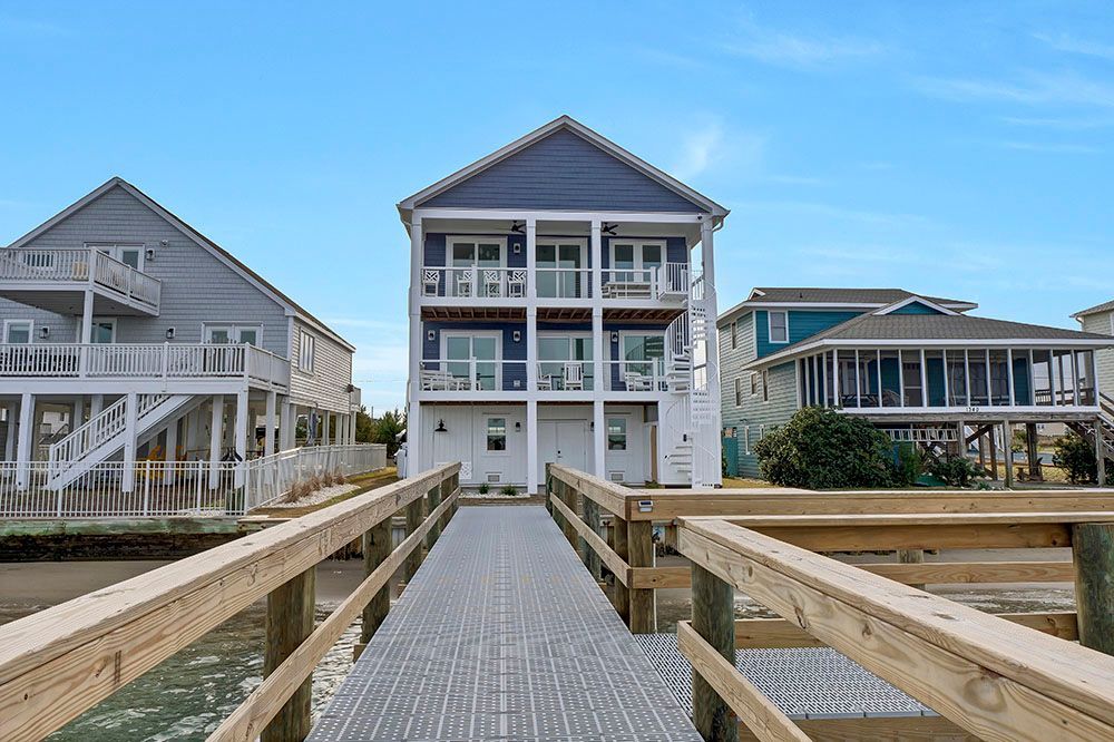 A large house with a dock leading to it