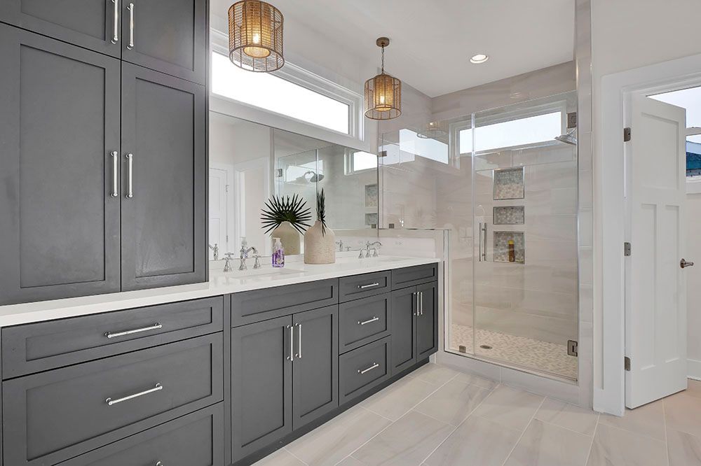 A bathroom with a walk-in shower and a sink.