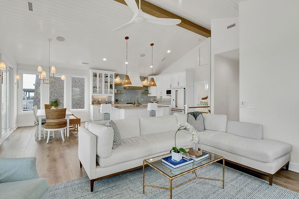 A living room filled with furniture and a ceiling fan