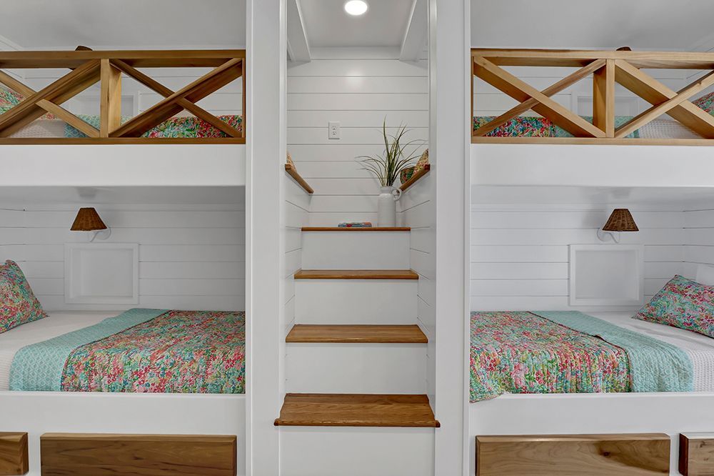 A bedroom with bunk beds and stairs