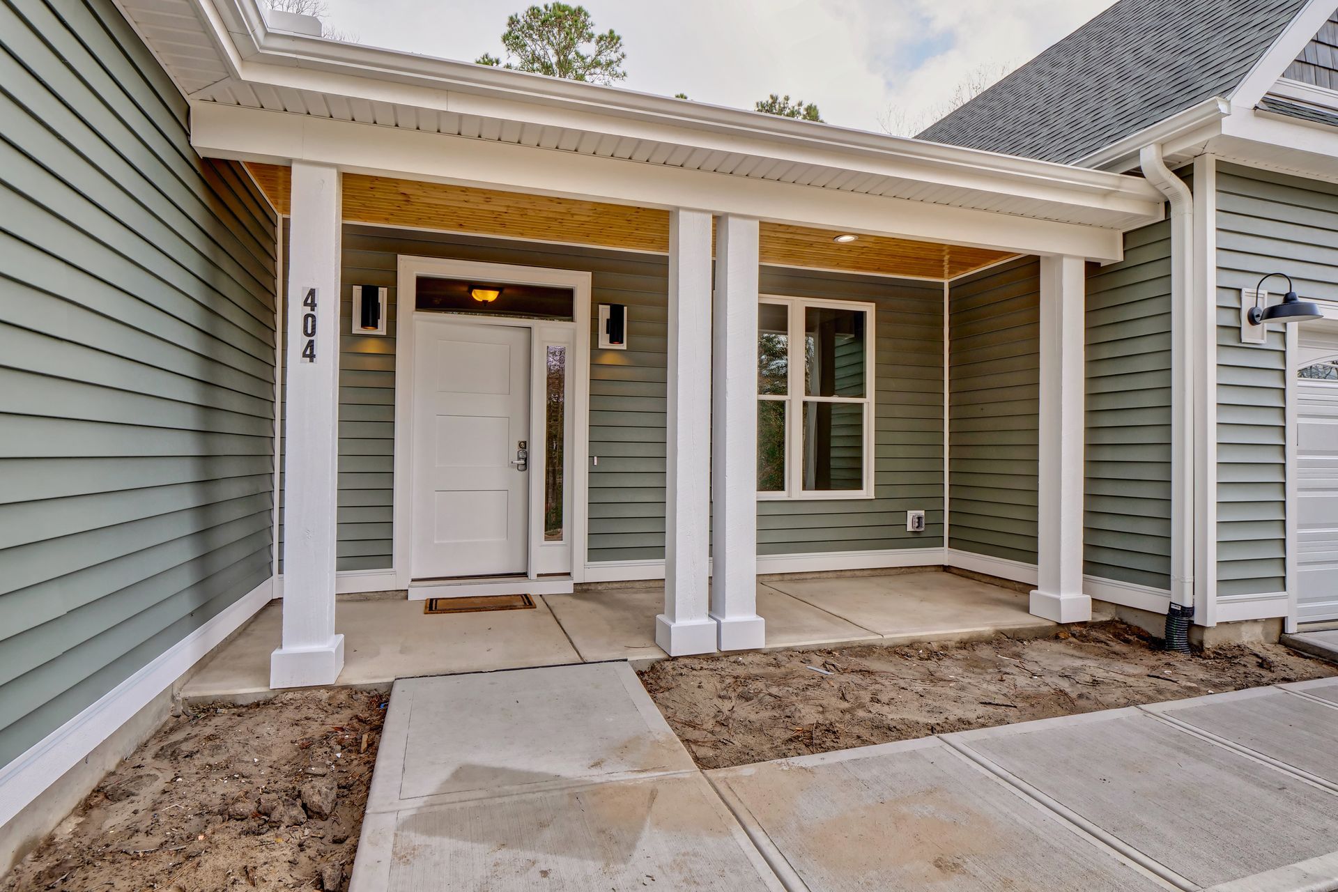 The front porch of a house with a white door