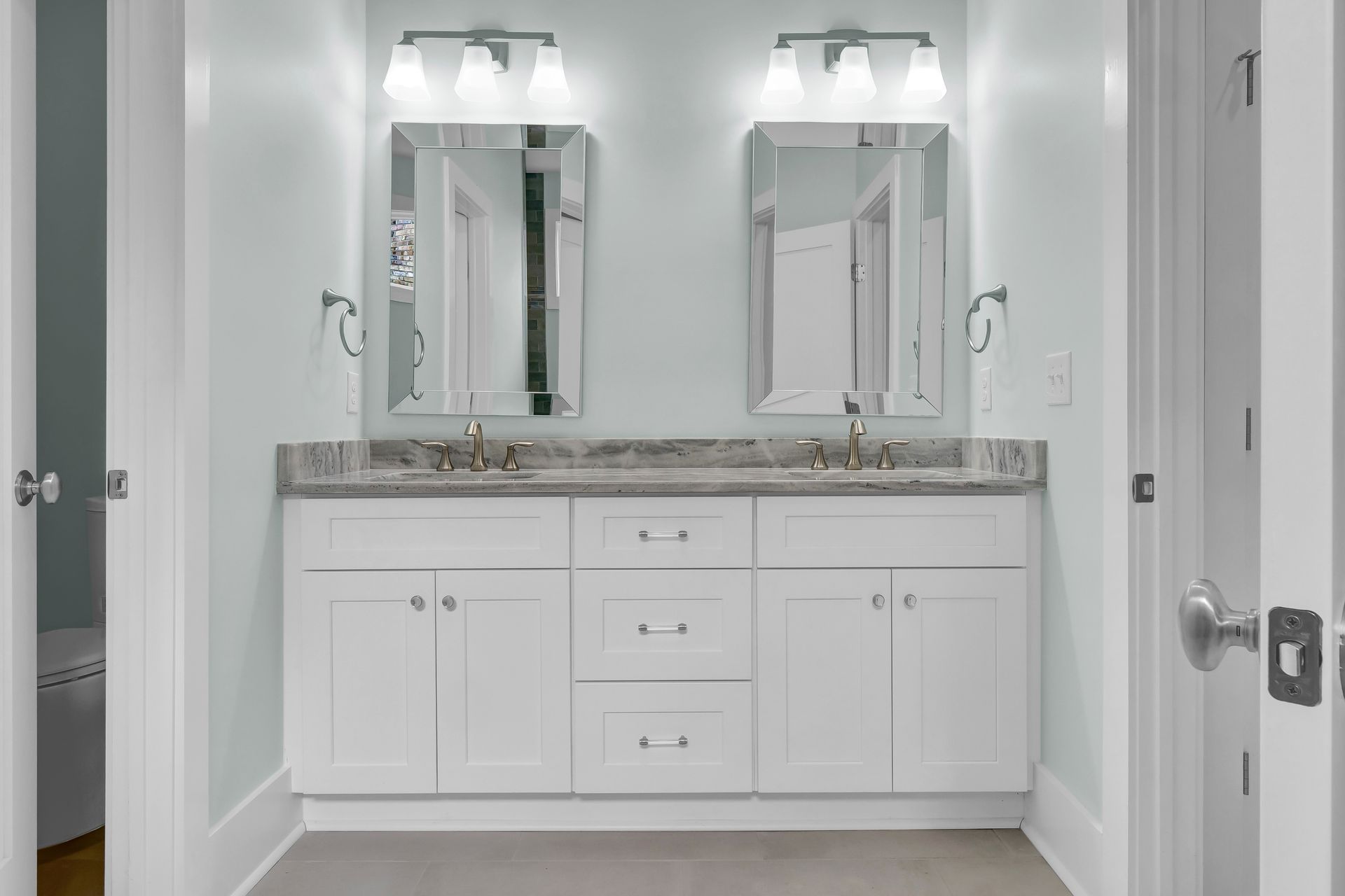 A bathroom with two sinks and two mirrors.