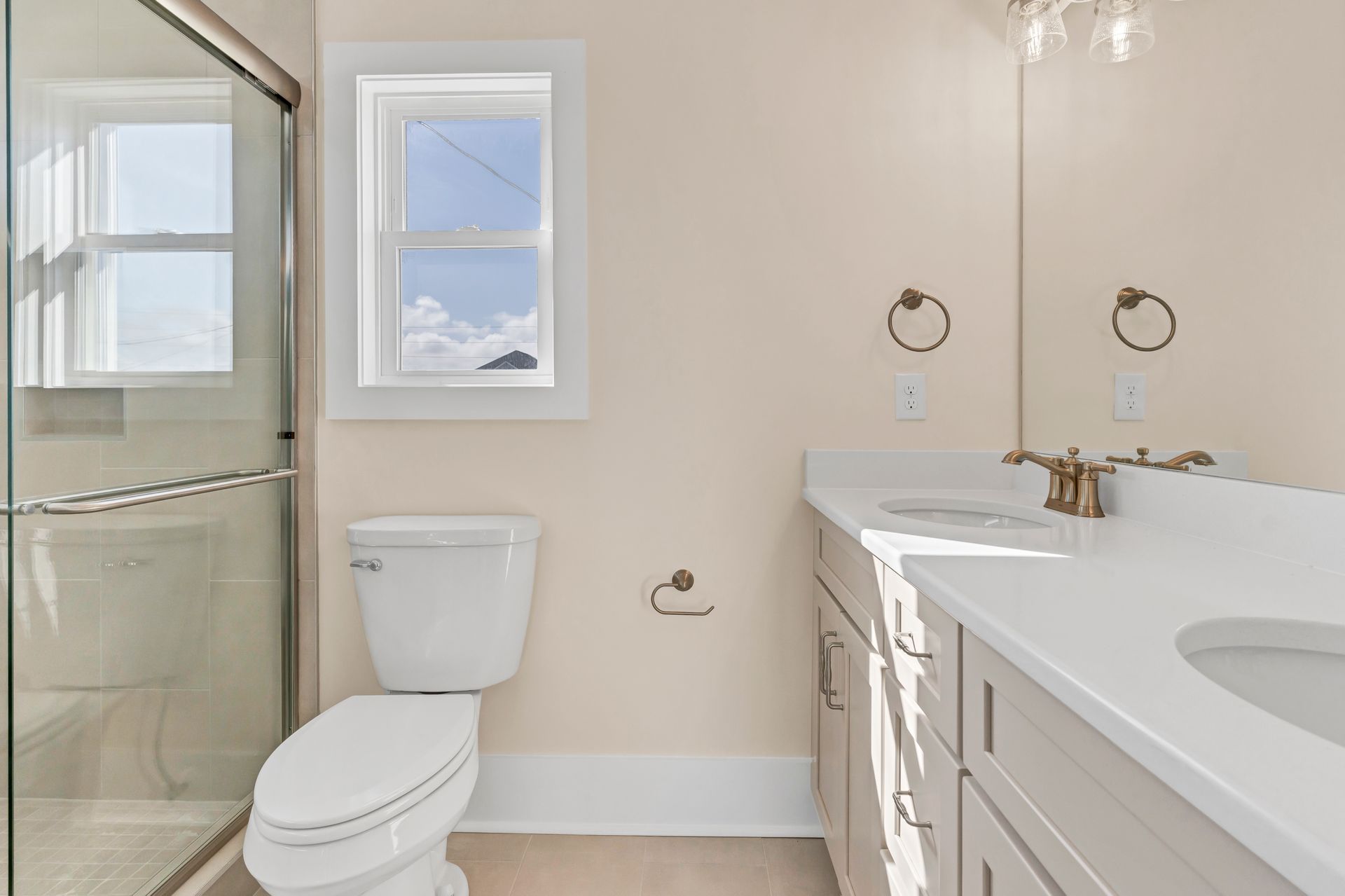 A bathroom with a toilet , sink , and shower.