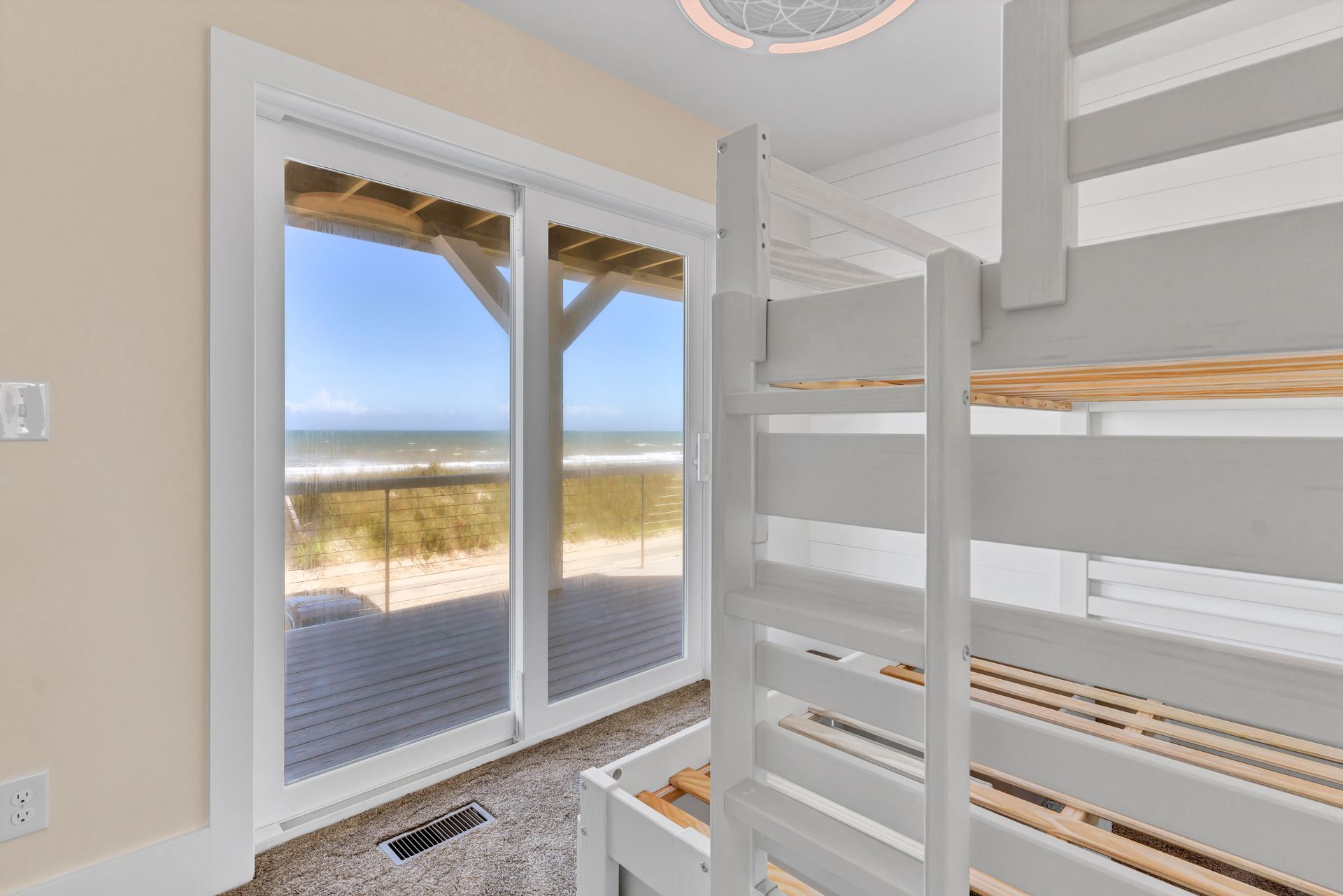 A bunk bed in a bedroom with a view of the ocean.
