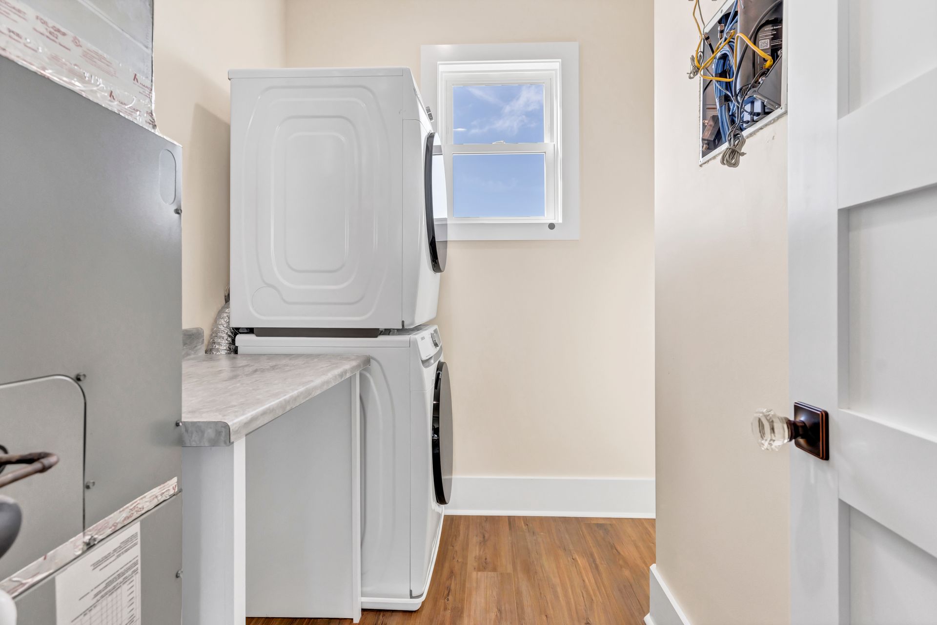 A laundry room with a washer and dryer stacked on top of each other.