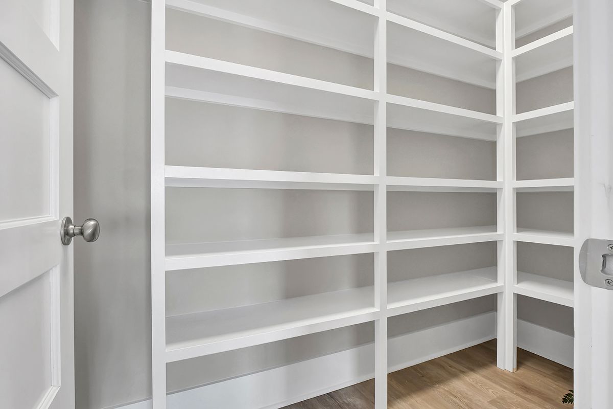 A walk-in pantry with lots of shelves