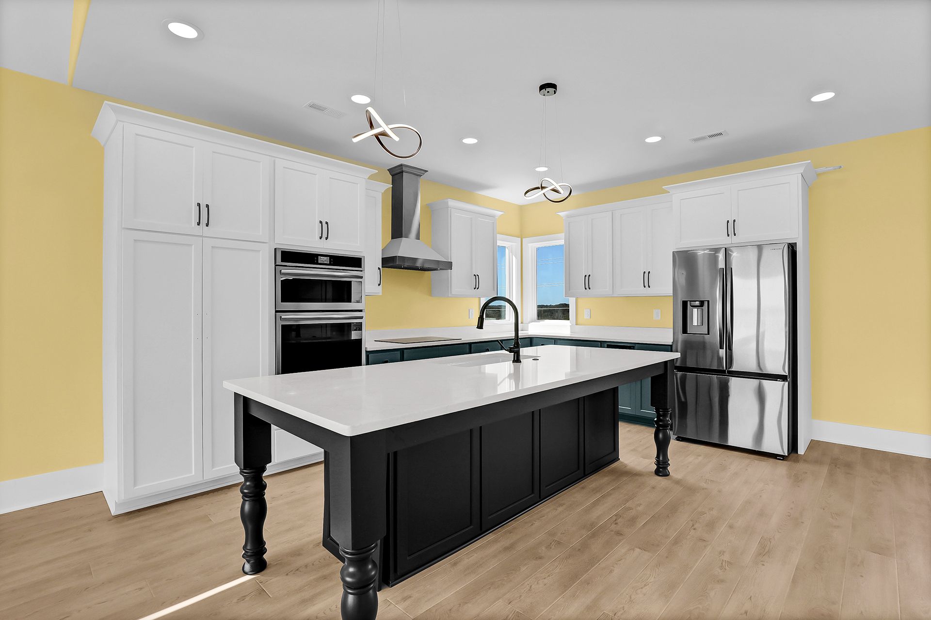 A kitchen with white cabinets and countertop