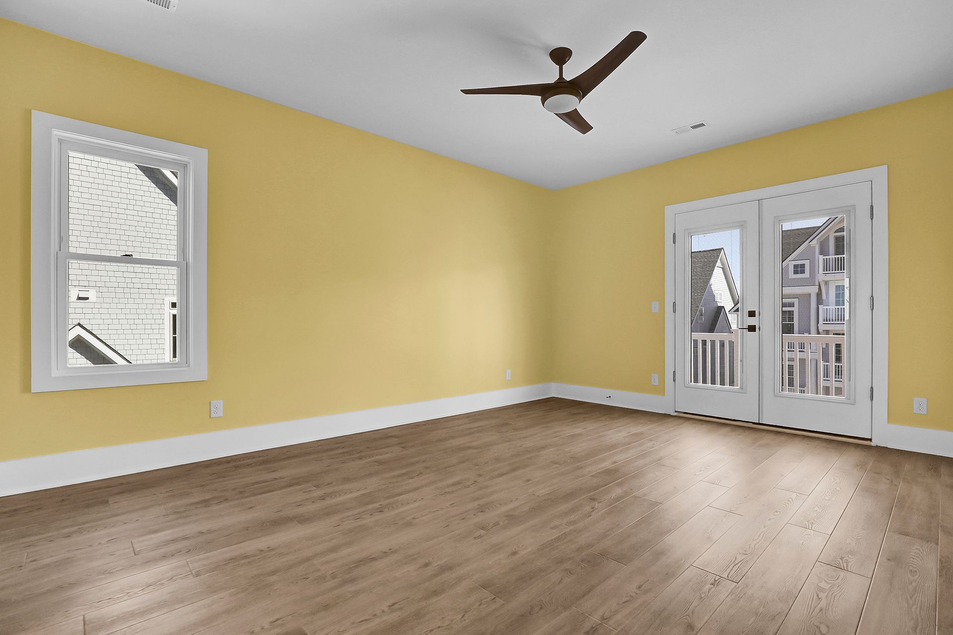 An empty room with yellow walls and glass door