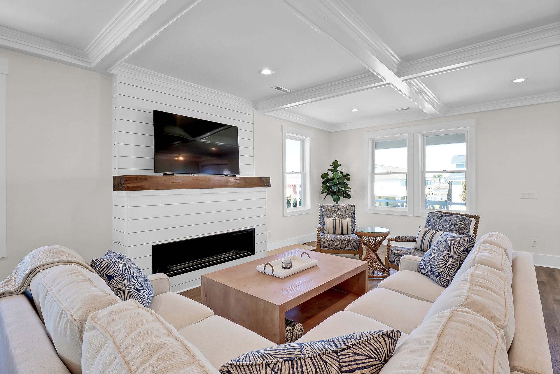 A living room with a fireplace and a flat-screen TV