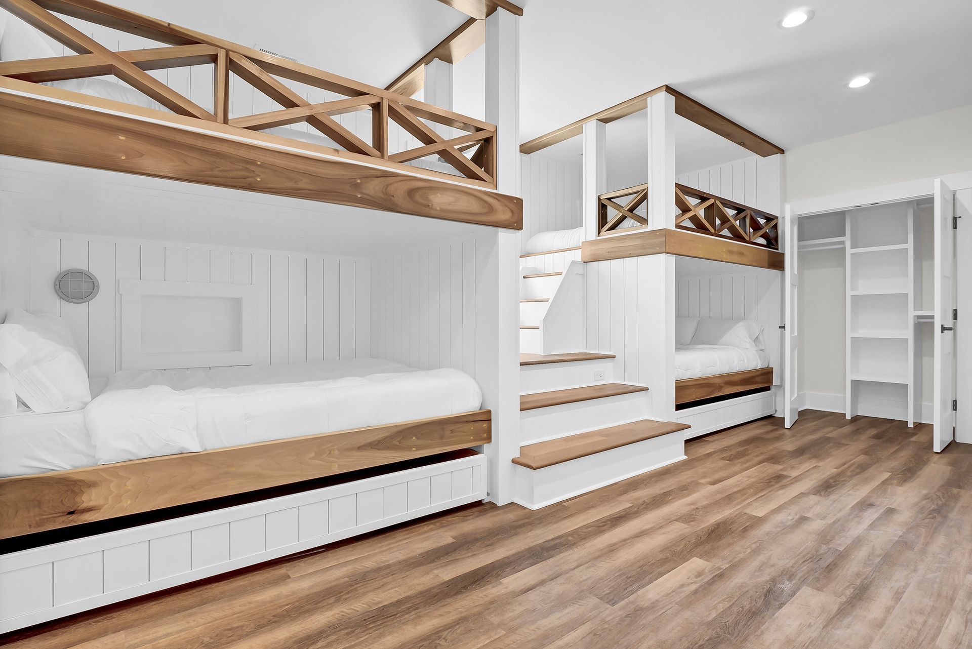 A bedroom with bunk beds and stairs