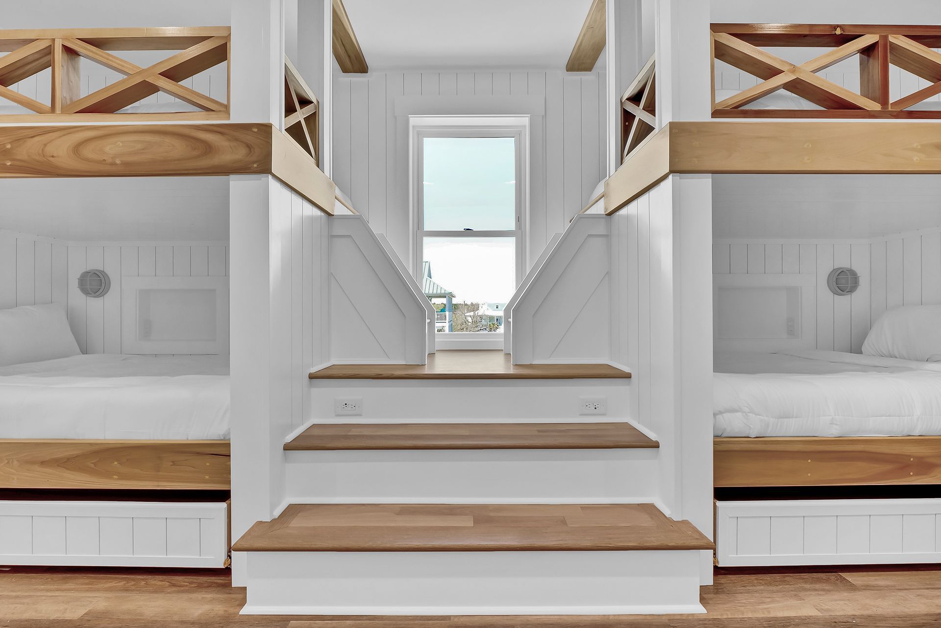 A room with bunk beds and stairs