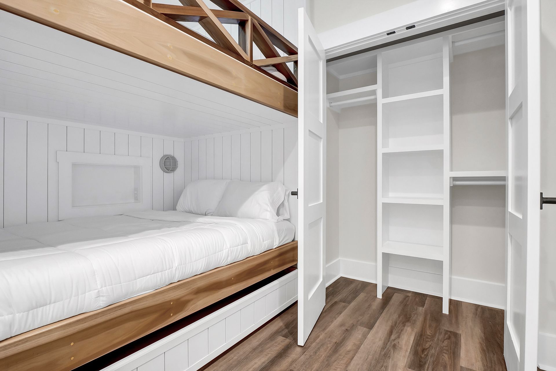 A bedroom with bunk beds and a closet