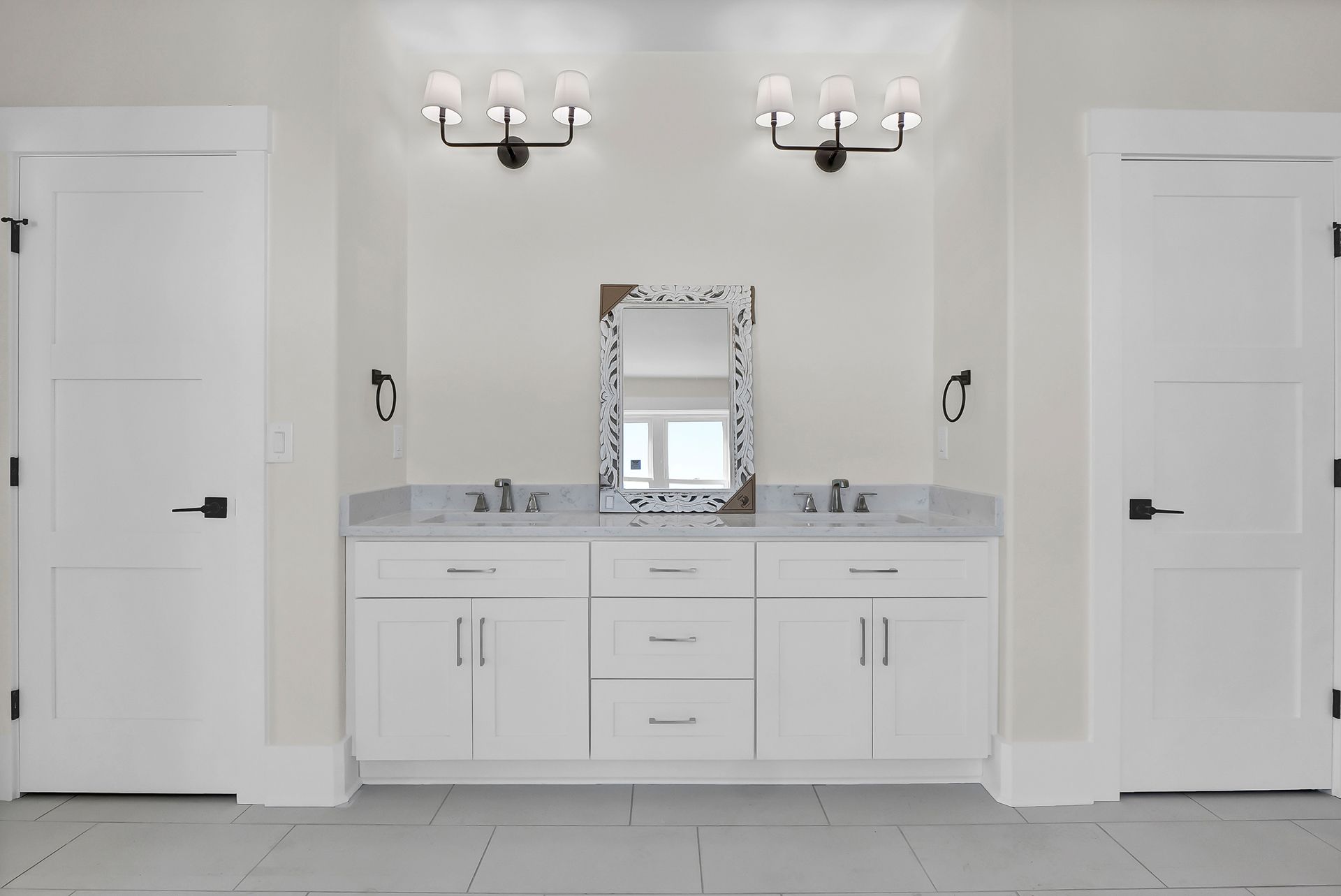 A bathroom with two sinks and a mirror
