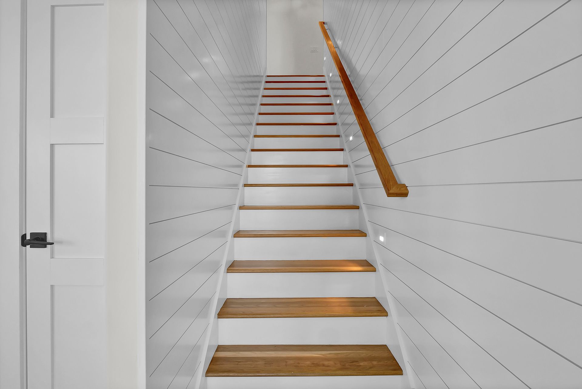 A set of stairs leading up to the second floor of a house