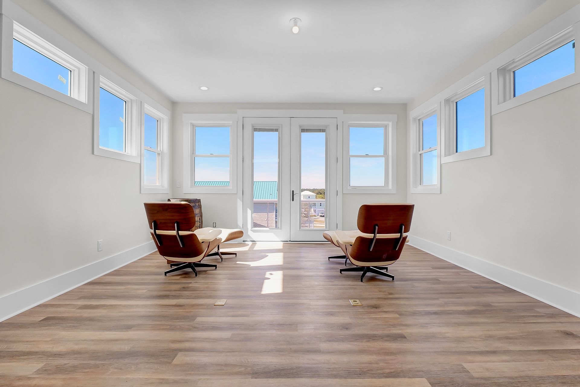 Two lounge chairs in the middle of a room