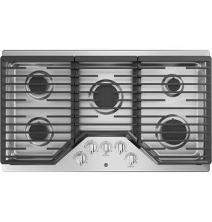 Stainless steel gas cooktop with five burners and black grates, control knobs.