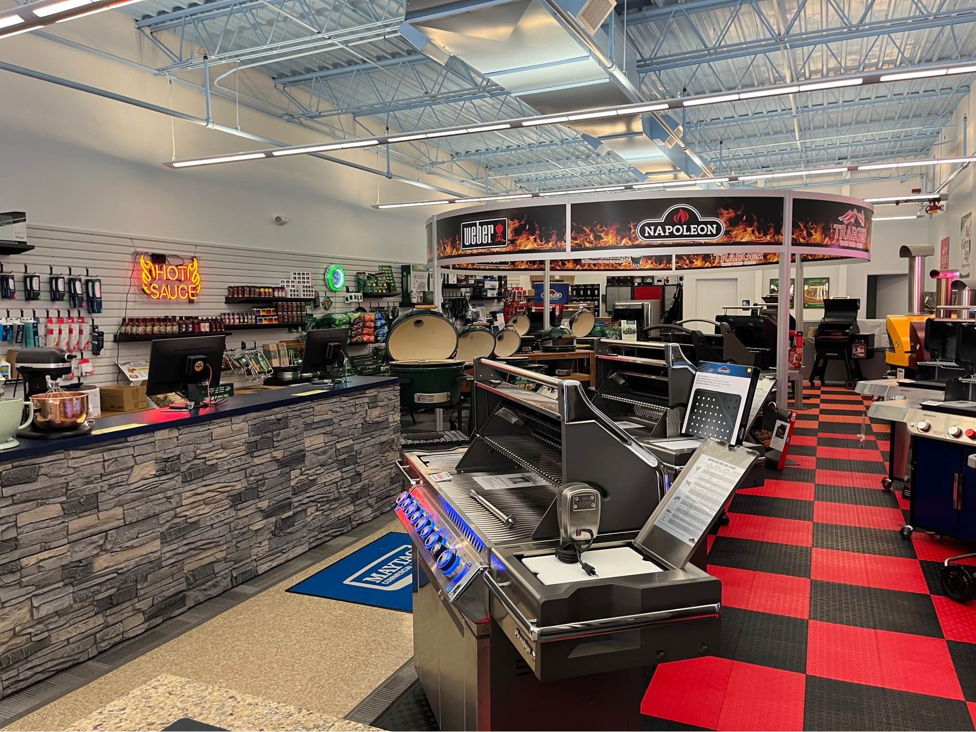 A large room with a checkered floor and a counter in a store.