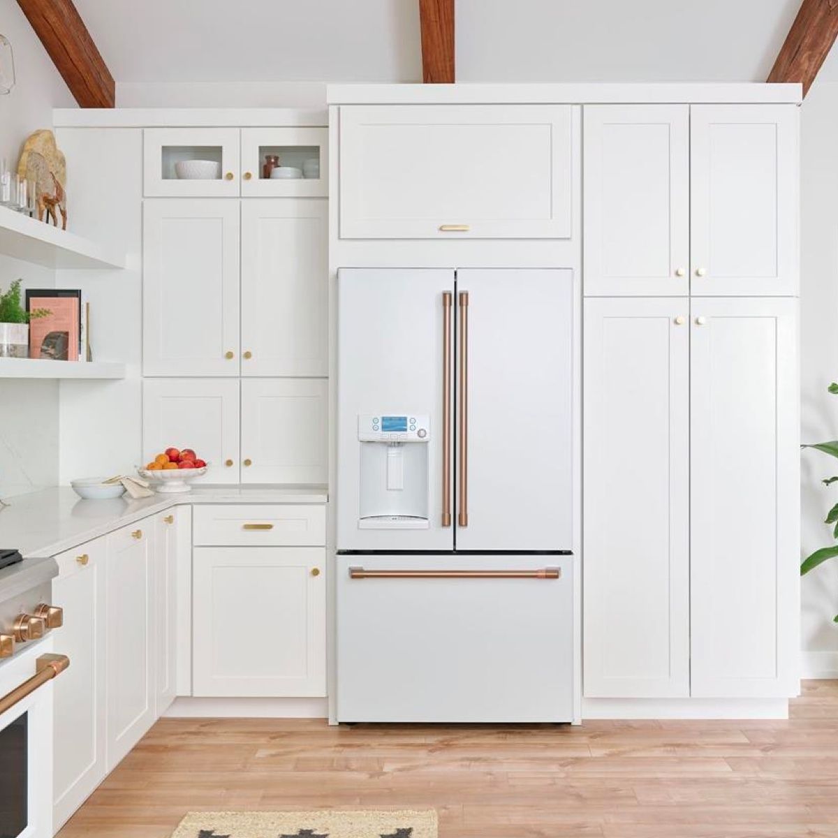 A kitchen with white cabinets and a white refrigerator