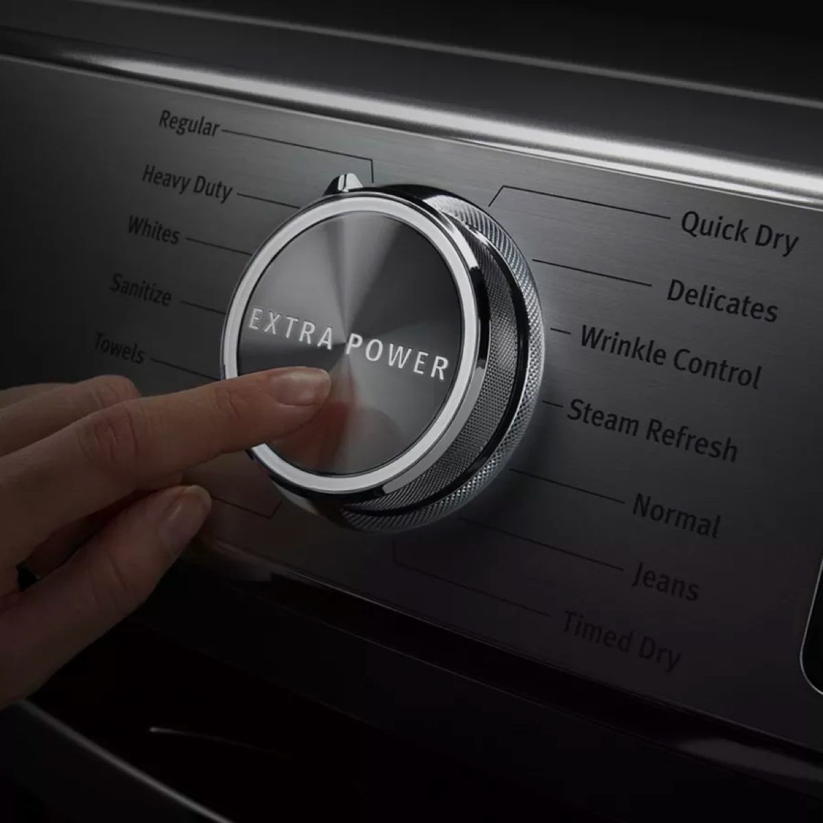 A person is pressing the extra power button on a washing machine