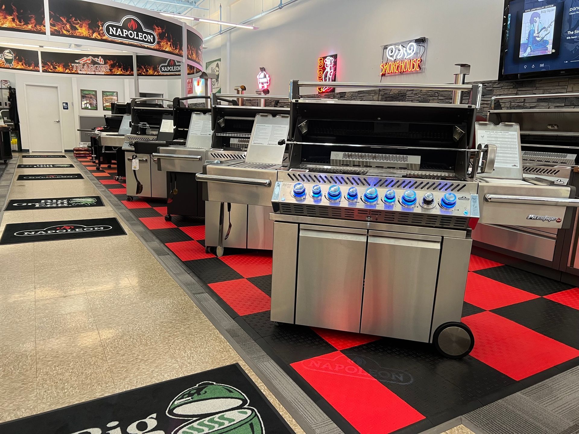 A row of grills are lined up in a store.