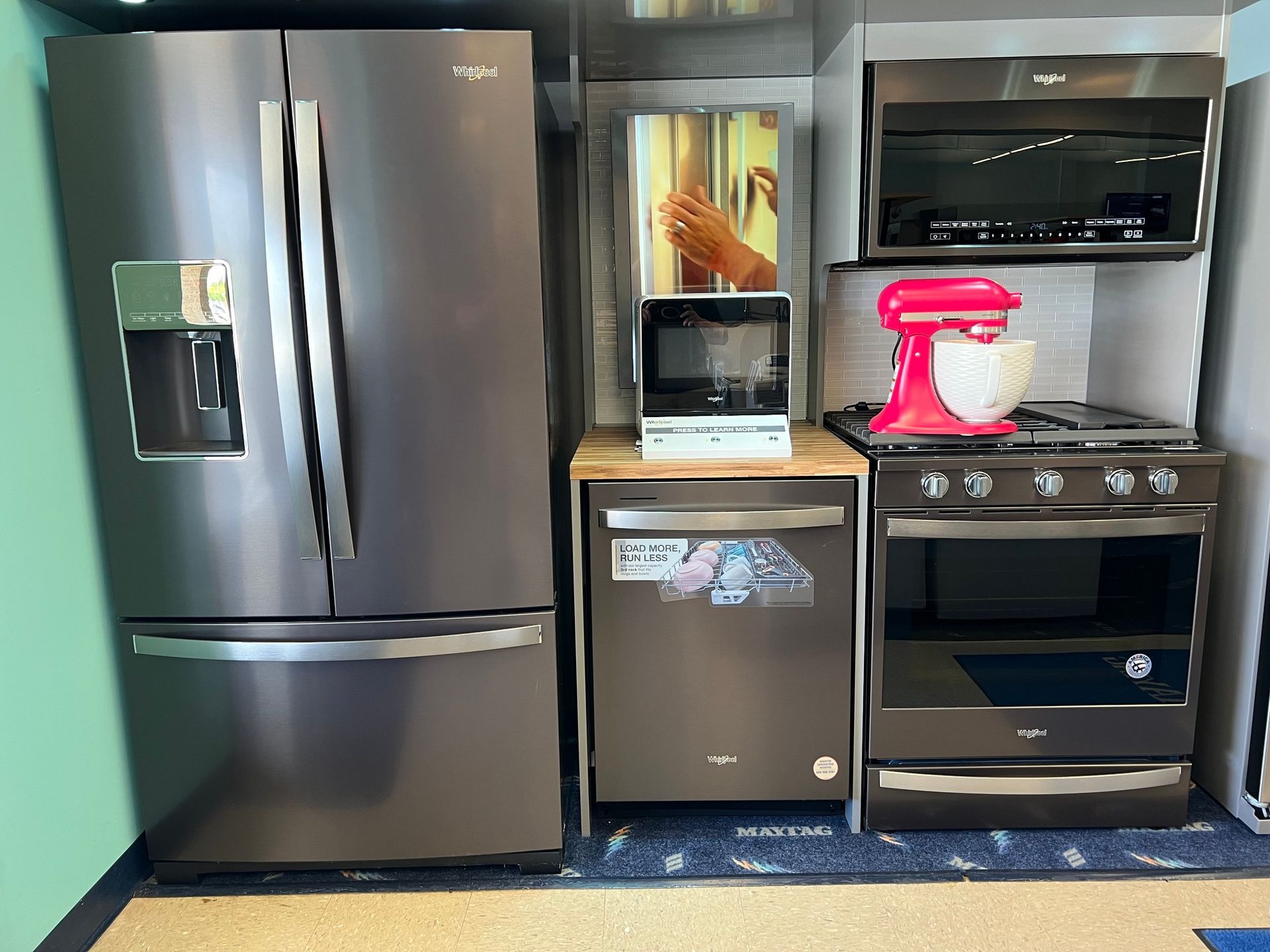 A kitchen with a refrigerator , dishwasher , stove and microwave.