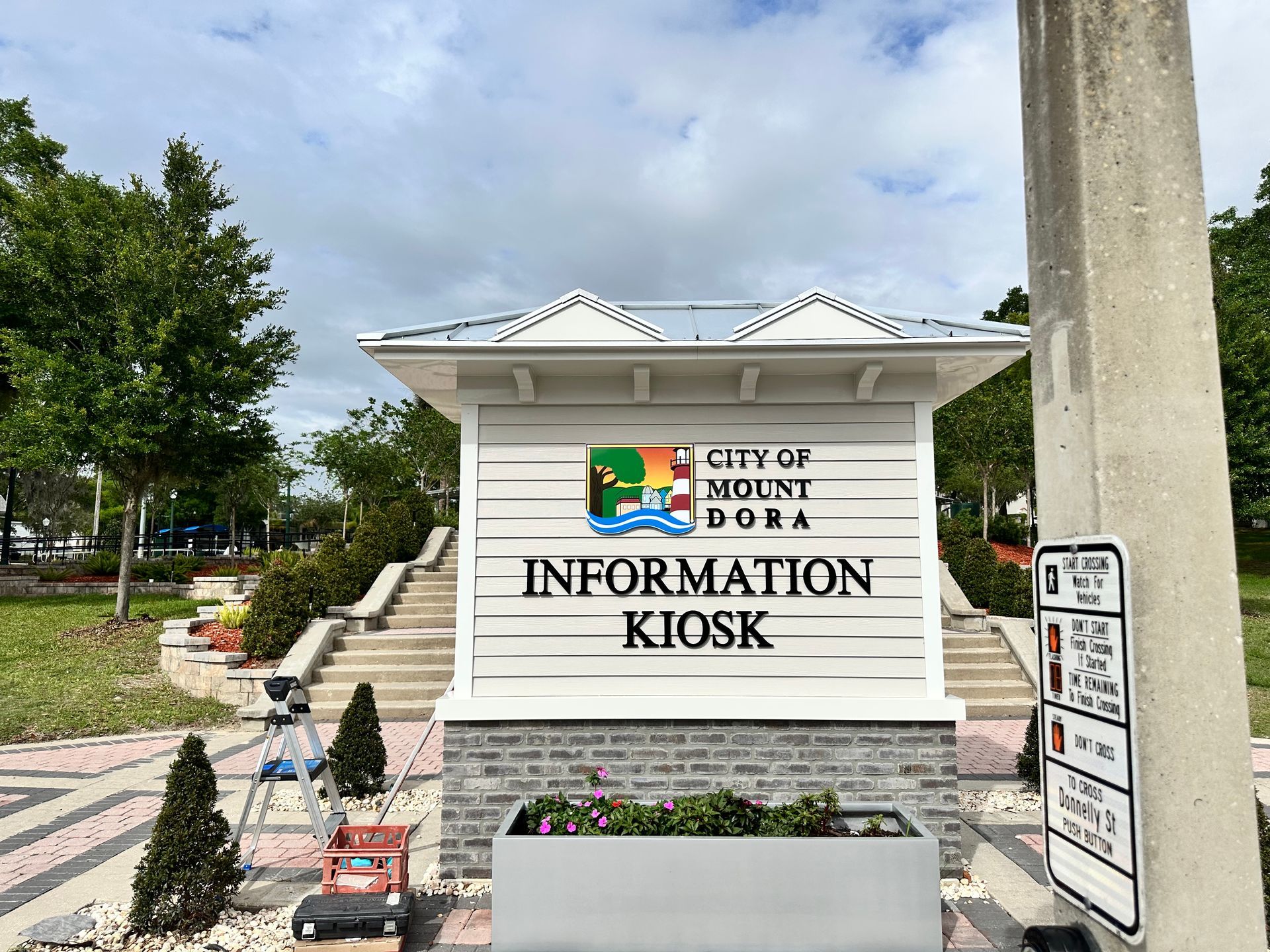 Crested wooden information kiosk with “City of North Port” sign in a landscaped park area