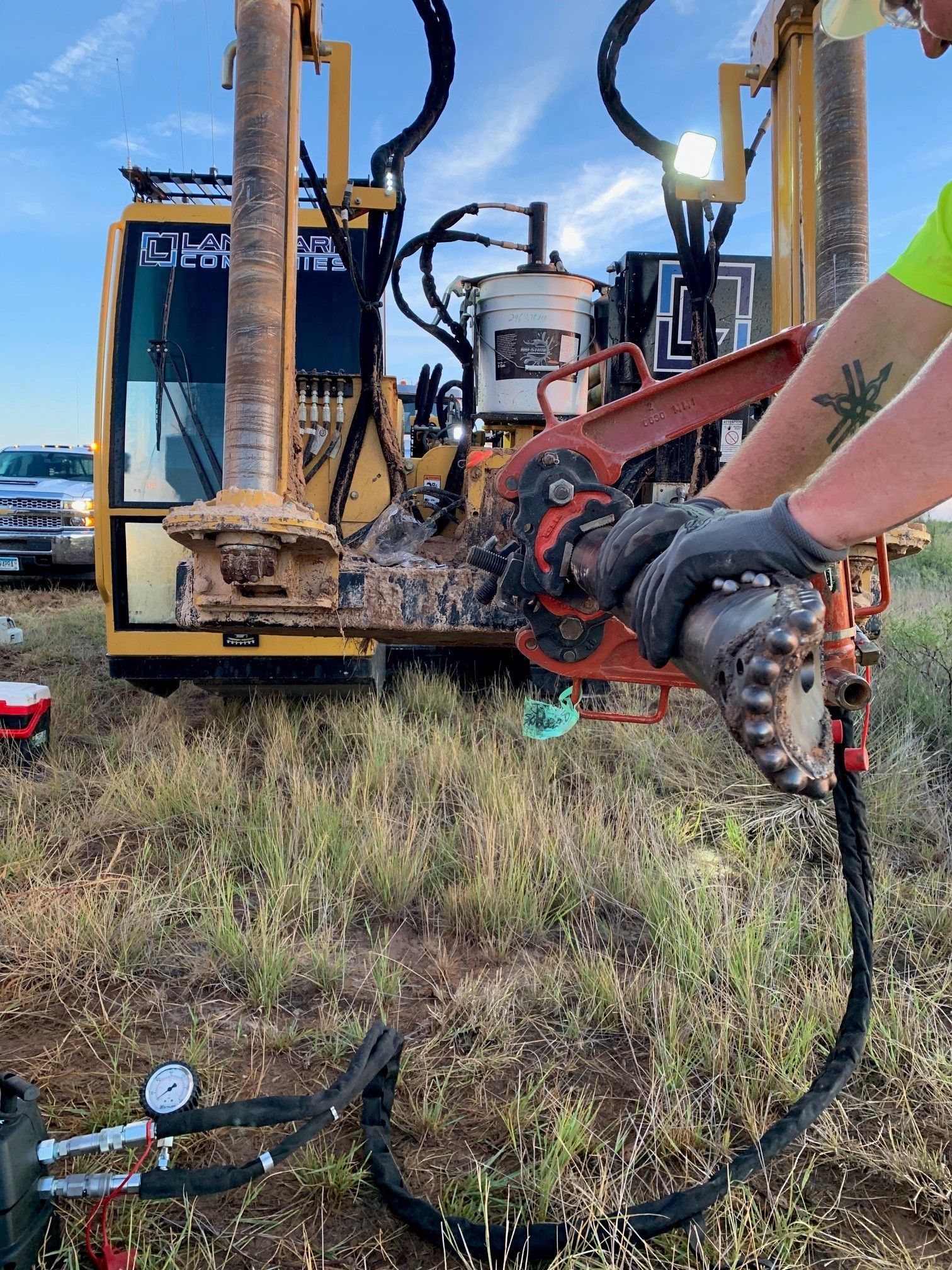 a man is working on a machine in a field .