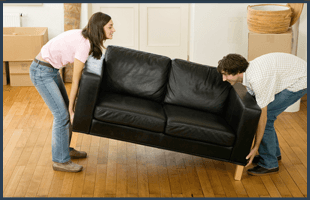 Couple moving sofa