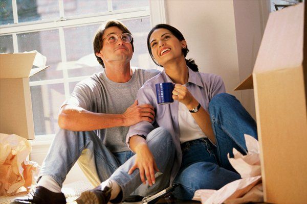 Couple sitting with moving boxes