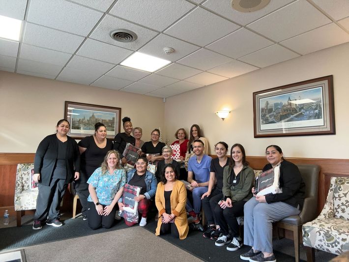 A group of people are posing for a picture in a room.