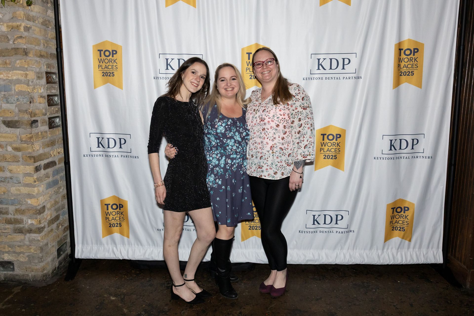 Three women are posing for a picture.