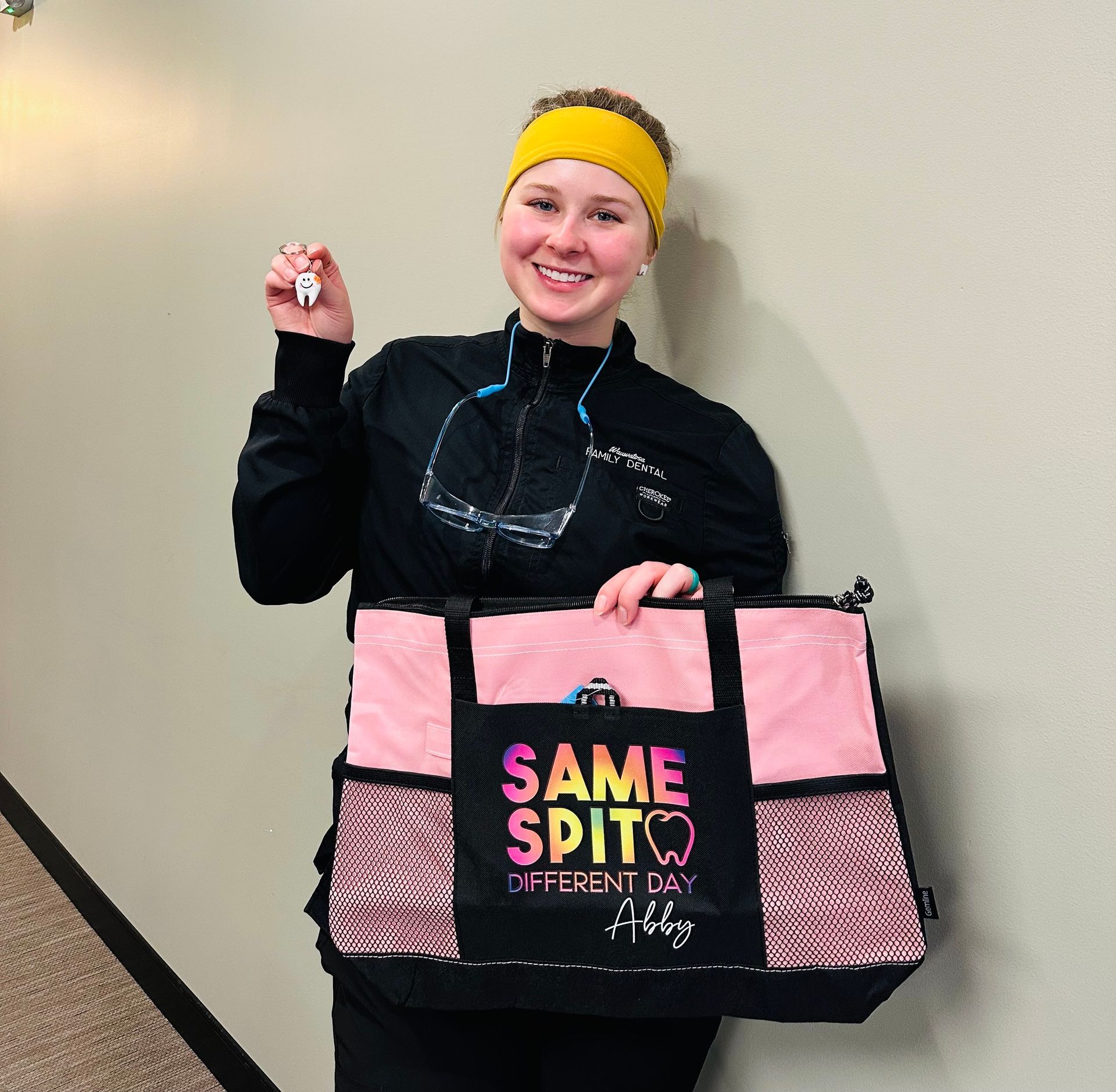 A woman is holding a pink bag that says same spit