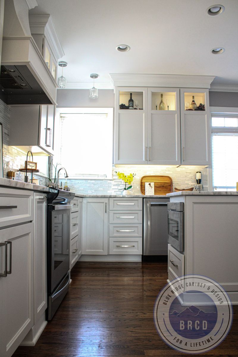 A kitchen with white cabinets and stainless steel appliances.