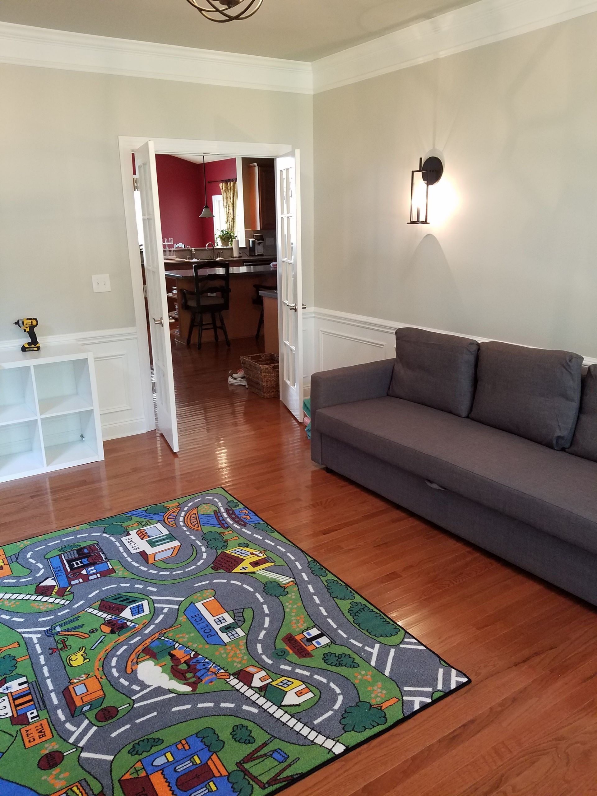 A living room with a couch and a rug on the floor