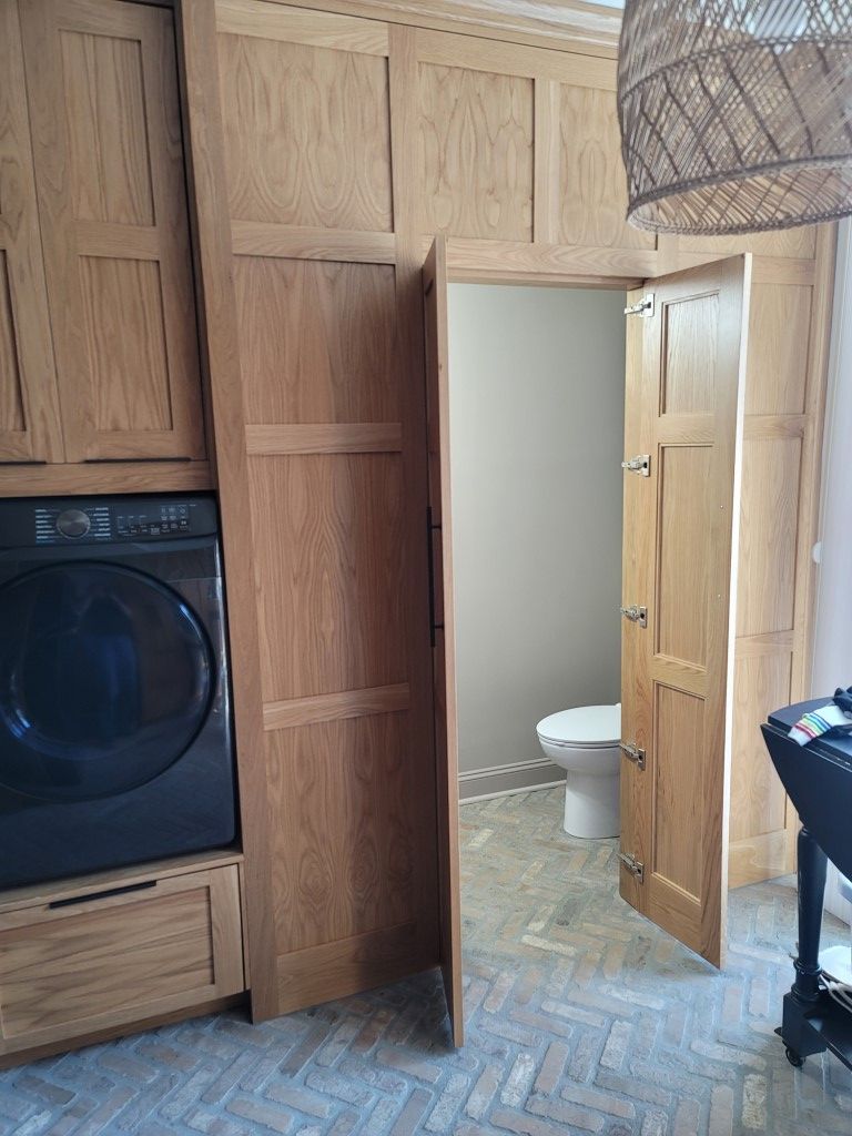 A laundry room with a washer and dryer and a toilet.