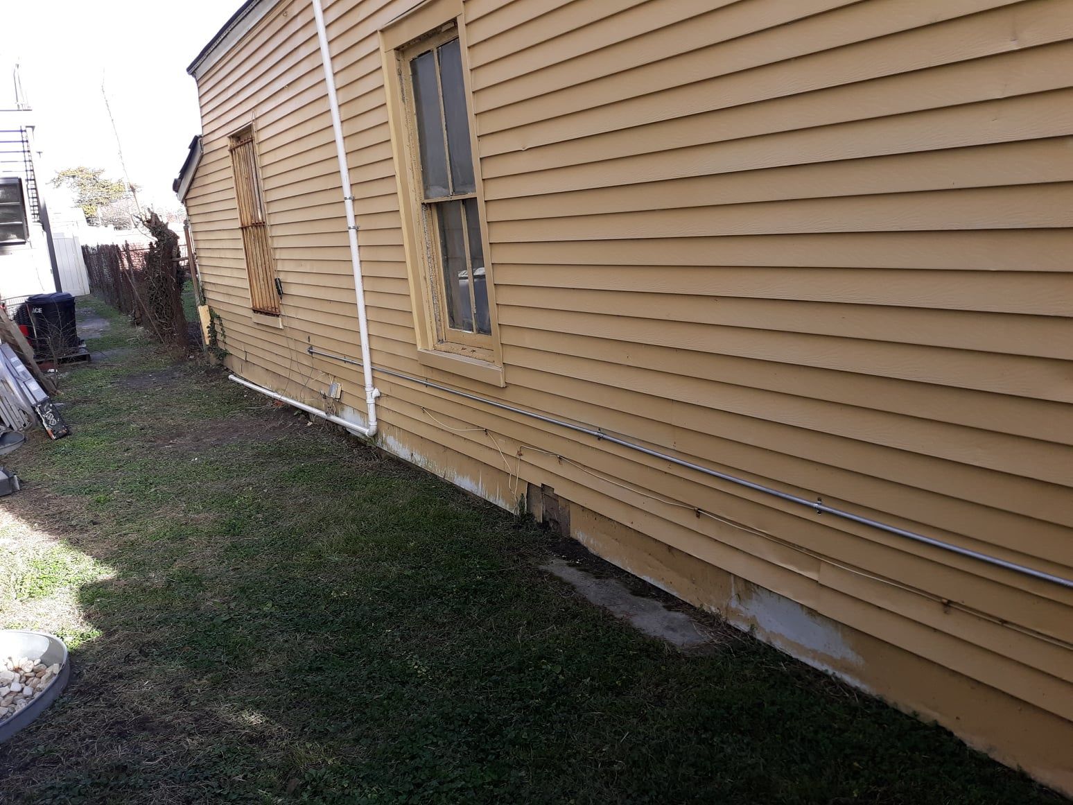 A house with a yellow siding and a window