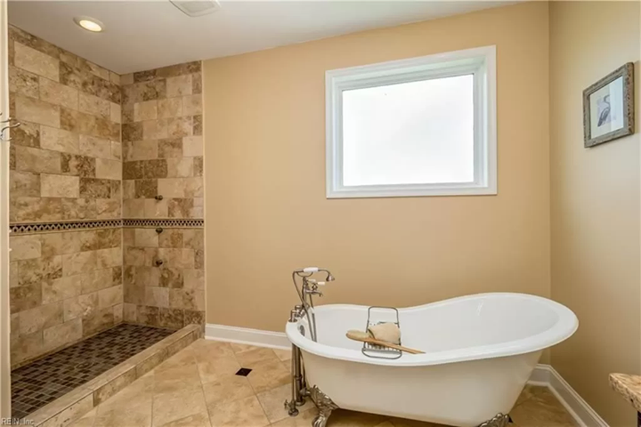 A bathroom with a claw foot tub