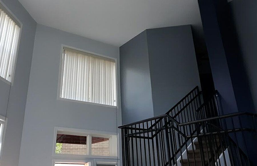 A living room with a staircase leading up to the second floor